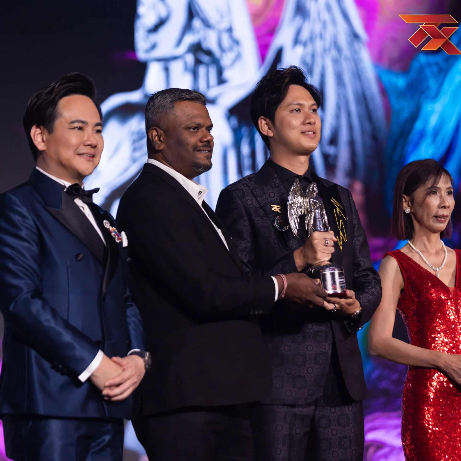 Wei Sheng receiving an award on stage at a Malaysian awards ceremony