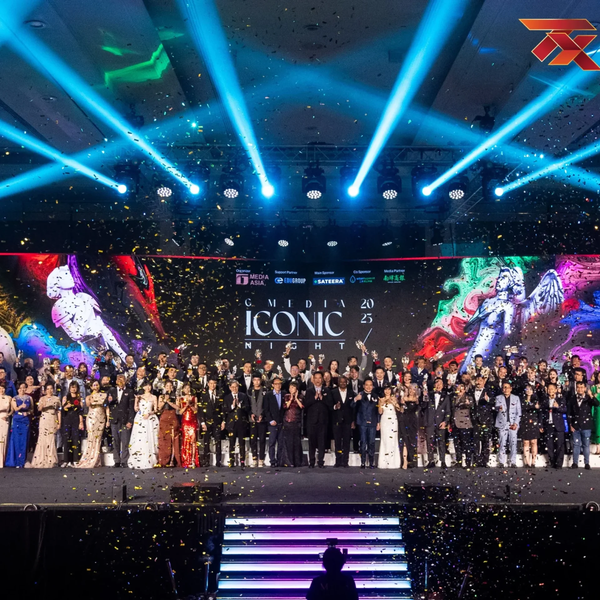 TX Academy traders and guests on stage at an awards gala night, with confetti and stage lights