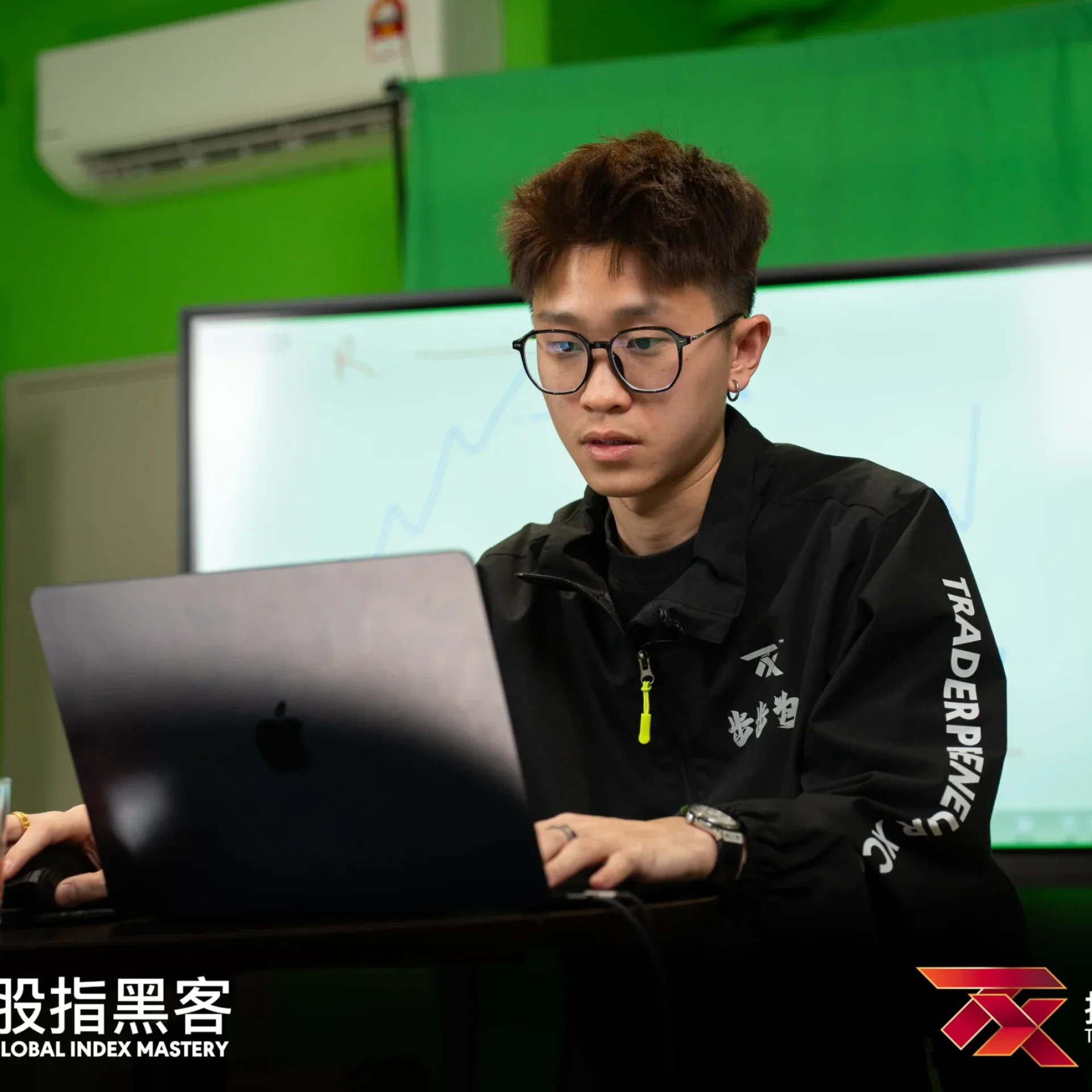 Lewis Lee analysing charts on a laptop in the TX studio